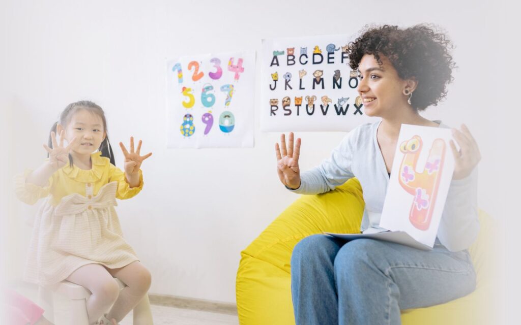 Women teaching a child the number 4